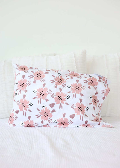 Apricot Blossom Blanket design featuring blush and mauve floral patterns on a pillow.