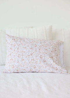 Dainty Floral Blanket featuring a soft floral pattern in pink and beige on a cozy pillow for stylish home decor.