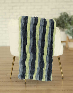 Hugs Bold Stripe Blanket draped over a chair, showcasing bold stripes in various colors and soft texture.