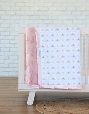 Princess Coach Blanket featuring crowns, bows, and carriages on a white background with apricot plush and satin ruffle.