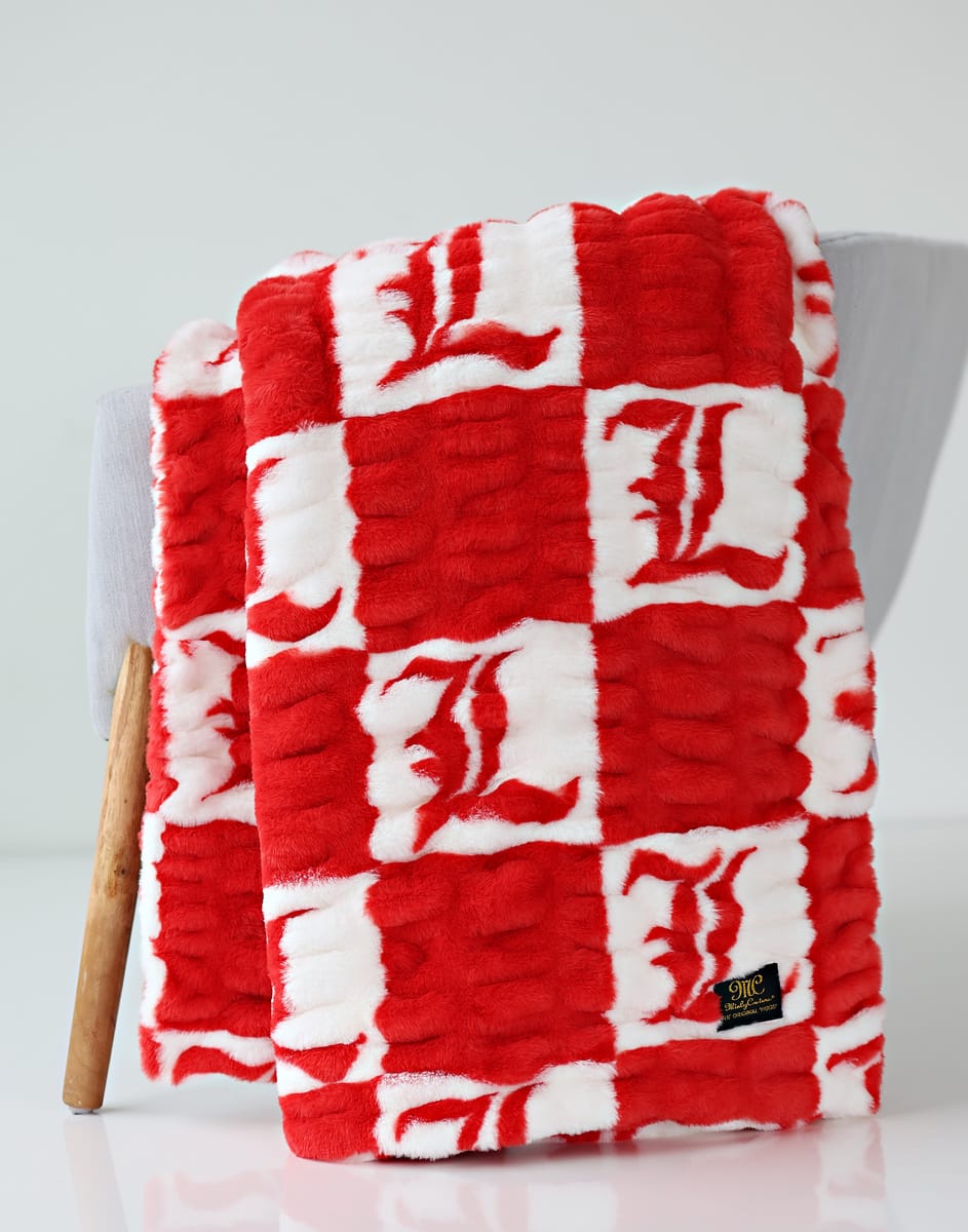 University of Louisville Blanket in soft red and white checker pattern, perfect for cozying up.