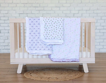 Itsy Bitsy Bows Blanket displayed on a crib with pastel designs, perfect for adding charm to any nursery.