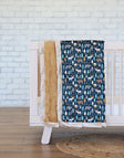Wildlife Blanket on crib showcasing moose, bears, trees on a navy background, perfect for little nature lovers.