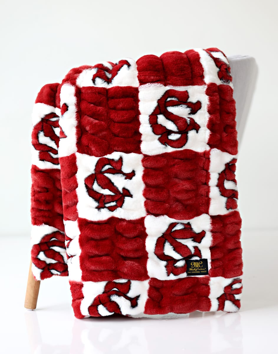 University of South Carolina blanket featuring a red and white blanket with a logo on a white background.