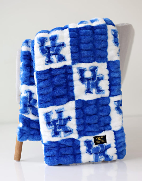 University of Kentucky blanket featuring a blue and white checkered blanket with a logo.