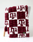 Texas A&M Aggies Blanket featuring a maroon and white design with collegiate logos.