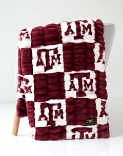 Texas A&M Aggies Blanket featuring a maroon and white design with collegiate logos.