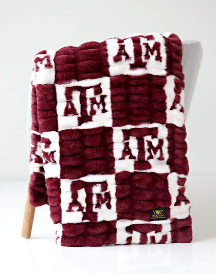 Texas A&M Aggies Blanket featuring a maroon and white design with collegiate logos.