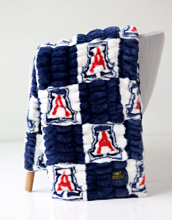 University of Arizona Wildcats Blanket draped over a chair, showcasing the team's colors and logo.