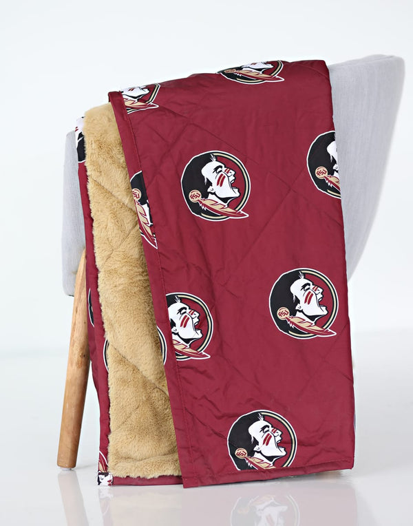 Florida State Seminoles Hooded Stadium Everywhere Blanket displayed on a chair, featuring maroon fabric with logo and plush interior.