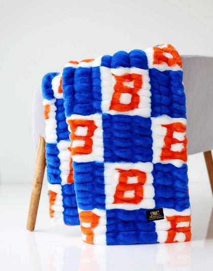 Boise State Broncos Blanket featuring blue and orange checkered pattern with iconic Bronco symbol.