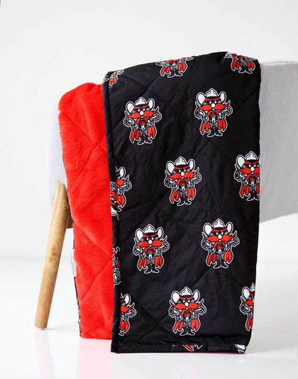 Everywhere Texas Tech Raiders Hooded Stadium Minky Couture blanket folded over a chair.