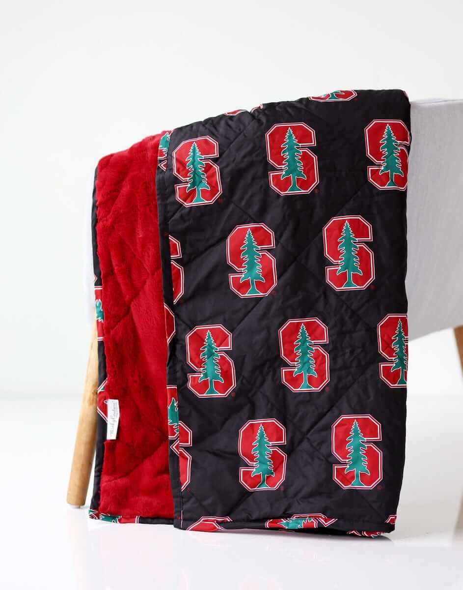 Stanford Cardinals Hooded Stadium Minky Couture blanket folded over a chair.