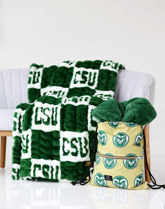 Colorado State Rams blanket on a chair with matching Colorado Rams drawstring bag beside it.