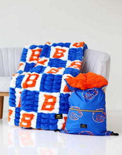 Boise State Broncos Blanket draped over a chair with matching blue and orange backpack.