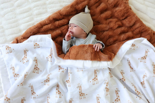 Plush Minky Couture Little Giraffe Blanket with playful giraffes, perfect for cozying up with a little one.