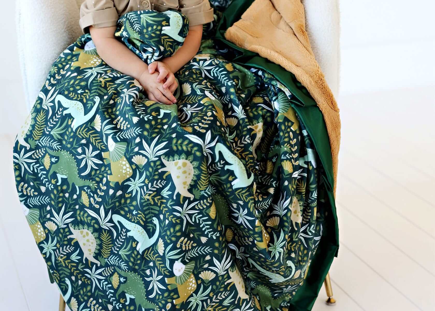 Little Dino Green Blanket featuring colorful dinosaurs on a dark green background, perfect for children.
