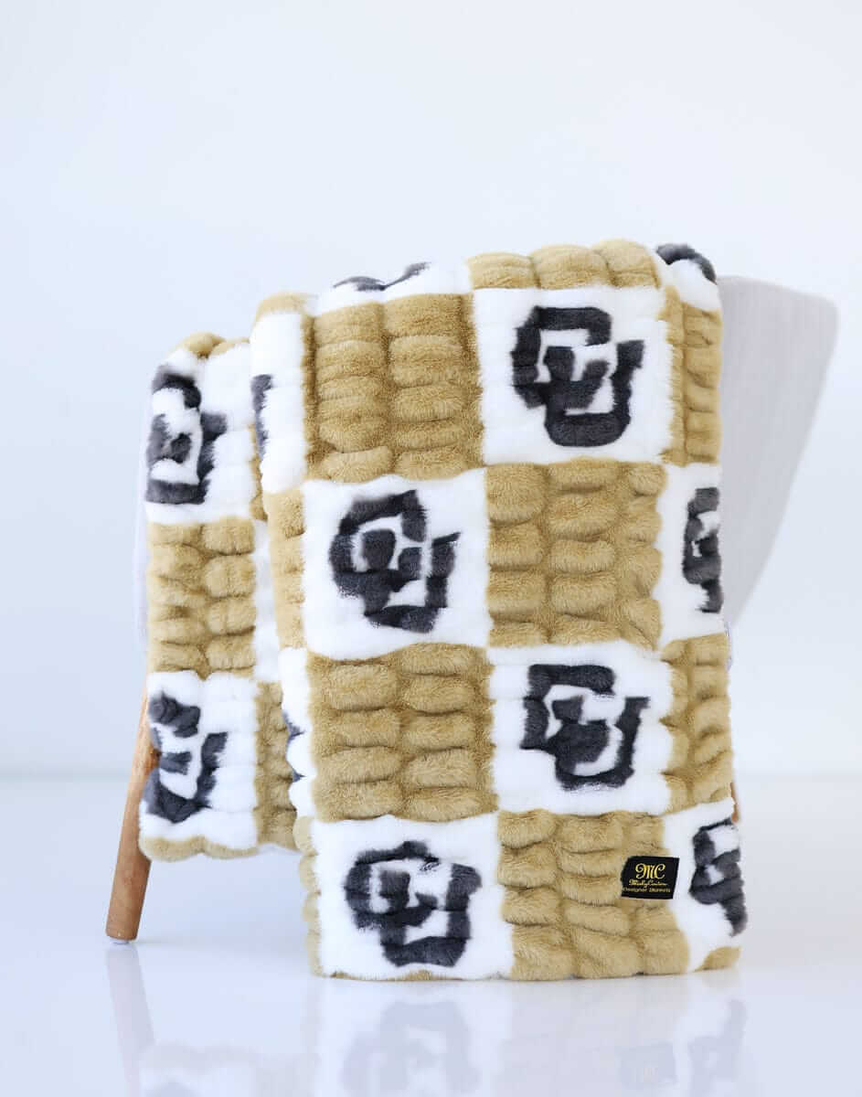 Colorado Buffaloes Blanket featuring soft, stretchy gold and cream check pattern with bold CU logos.
