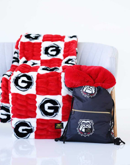 Georgia Bulldogs Hooded Stadium Blanket displayed on a chair with coordinating backpack.