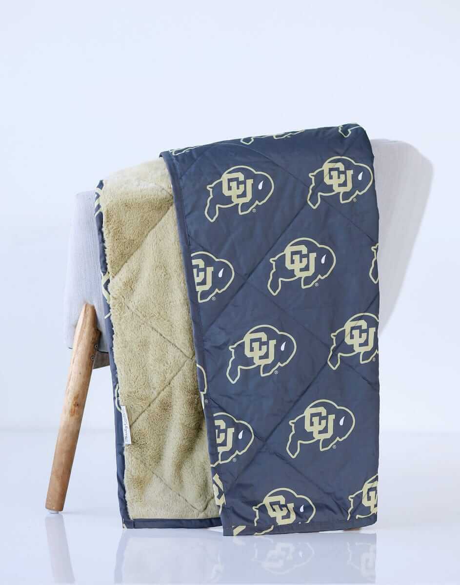 Colorado Buffaloes Hooded Stadium Blanket displayed on a chair, featuring a bold Buffalo logo.