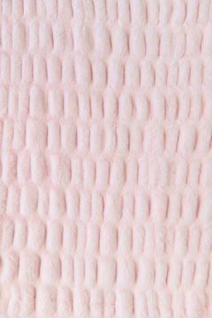 Close-up of a textured pink fabric blanket
