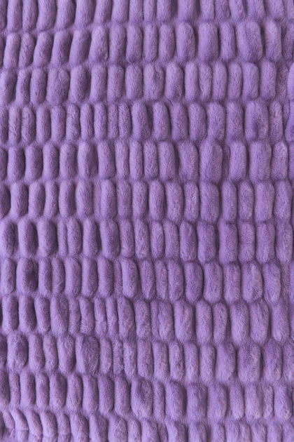 A close-up of a textured purple stretchy blanket.