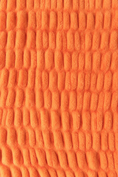 A close-up of an orange colored blanket.