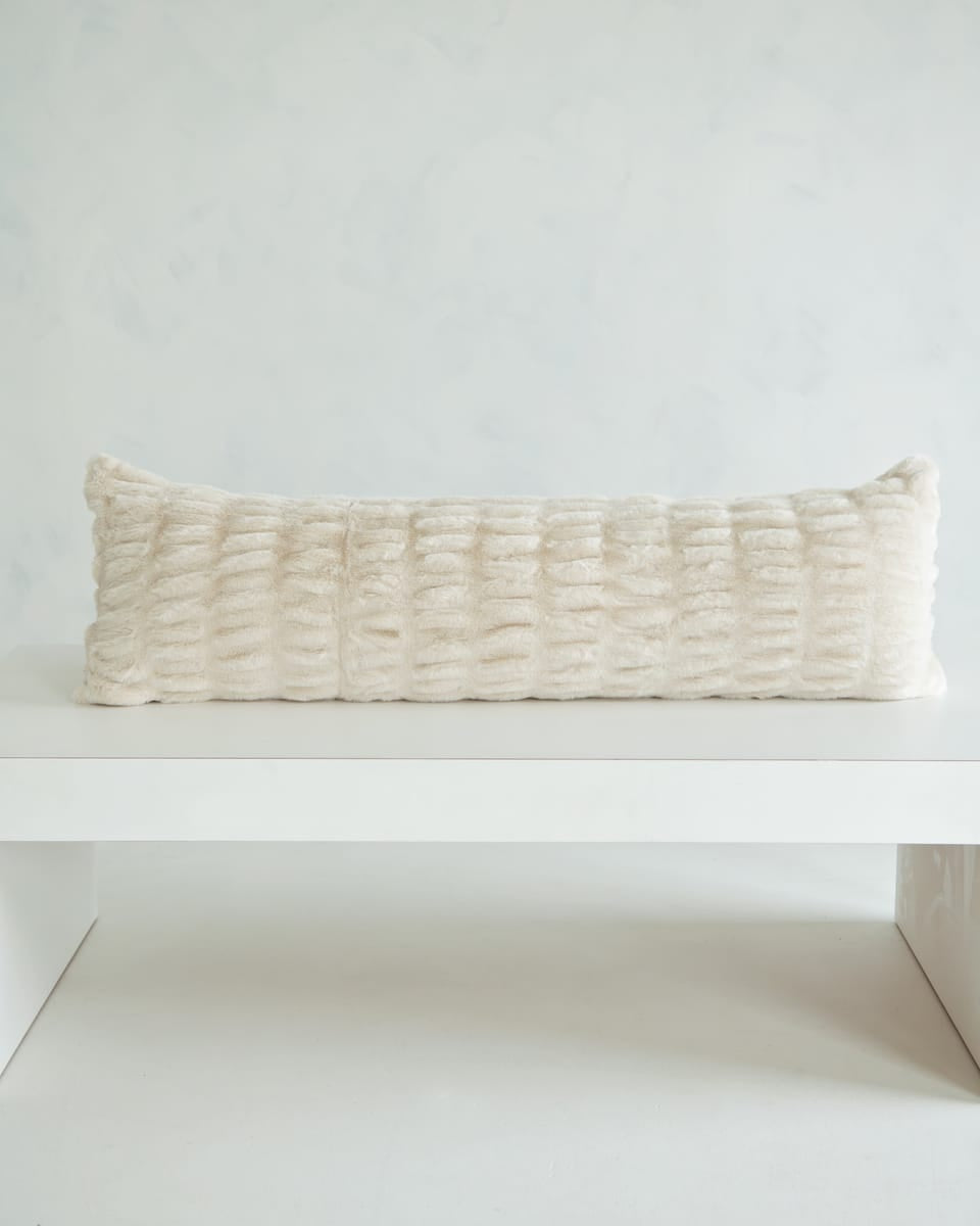 Hugs Ancient Scroll Sham on a white table, showcasing its soft and cozy texture in timeless off-white.