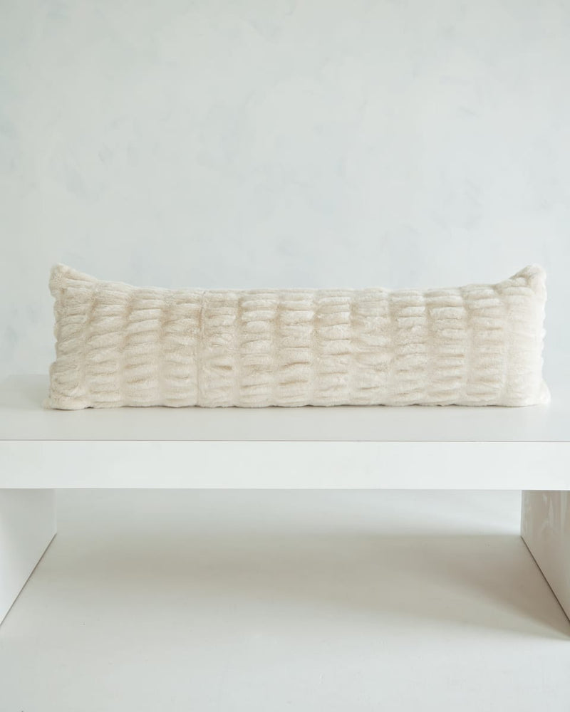 Hugs Ancient Scroll Sham on a white table, showcasing its soft and cozy texture in timeless off-white.