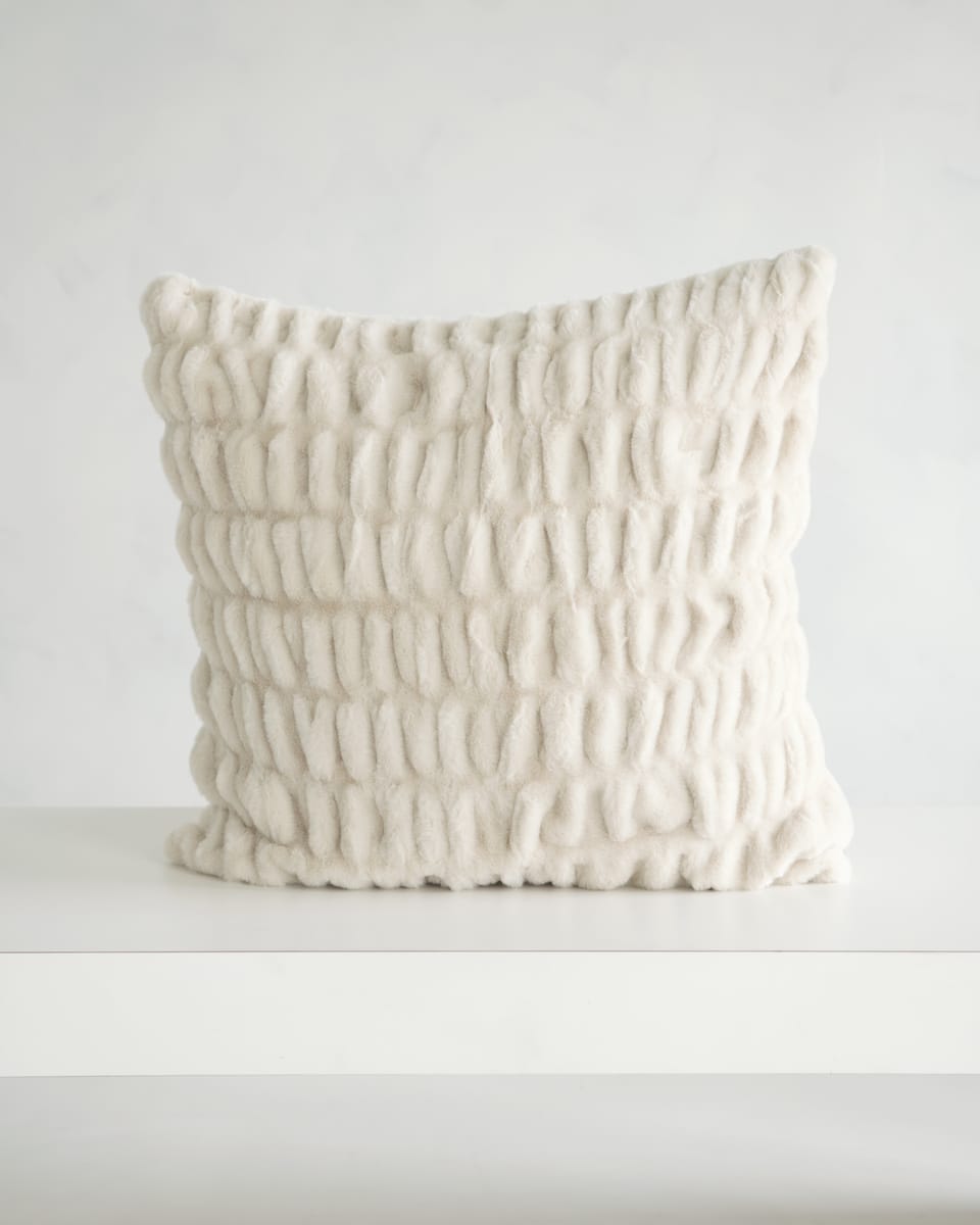 Hugs Ancient Scroll Sham featuring a plush textured fabric in off-white color on a minimalistic table.