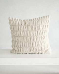 Hugs Ancient Scroll Sham featuring a plush textured fabric in off-white color on a minimalistic table.