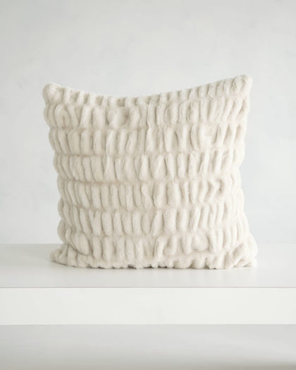 Hugs Ancient Scroll Sham featuring a plush textured fabric in off-white color on a minimalistic table.