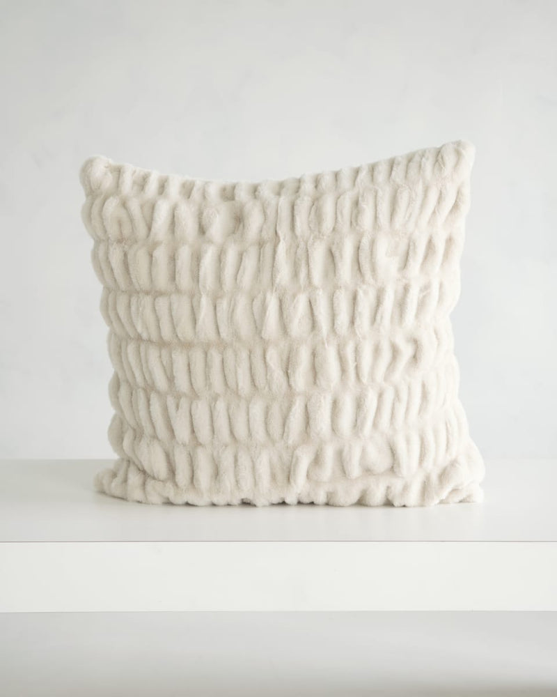 Hugs Ancient Scroll Sham featuring a plush textured fabric in off-white color on a minimalistic table.