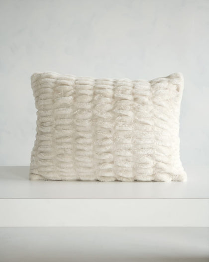 Hugs Ancient Scroll Sham displayed on a table, showcasing its soft, cozy texture in off-white.