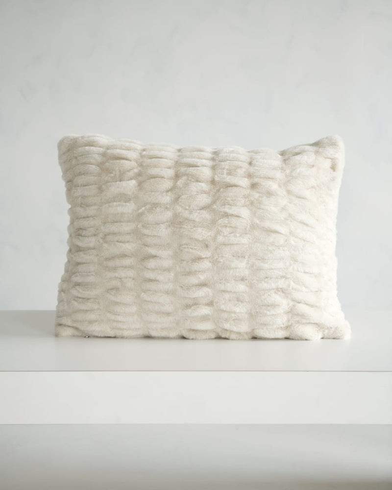 Hugs Ancient Scroll Sham displayed on a table, showcasing its soft, cozy texture in off-white.