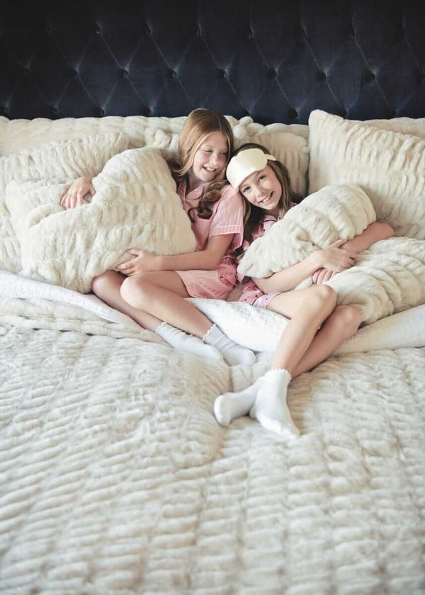 Bed with textured Minky Couture Hugs Ancient Scroll Sham pillows and duvet.