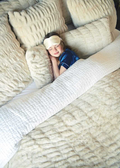 Child resting among Hugs Ancient Scroll Minky Couture duvet and matching shams.