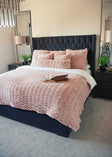 Pink Minky Couture Hugs Blush Duvet bedding styled on a bed.