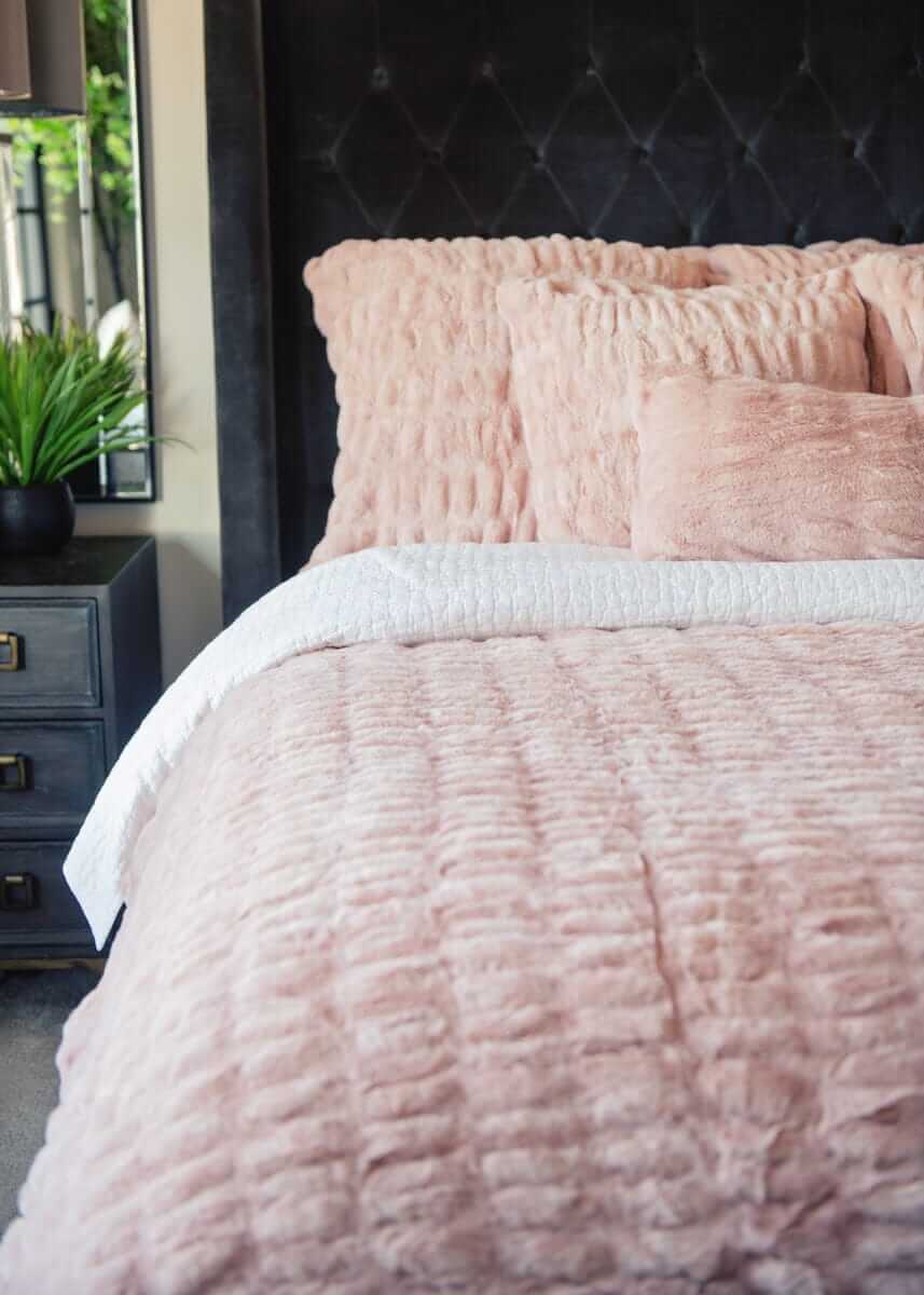 Hugs Blush Duvet Minky Couture bedding with textured pillows on a bed.