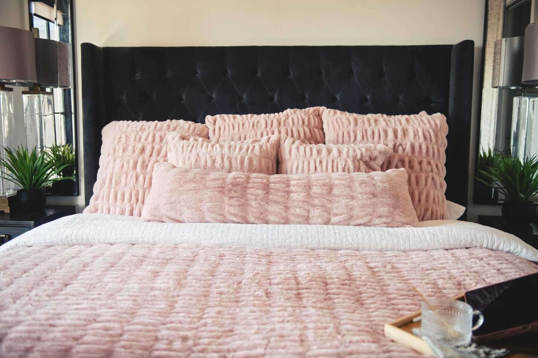 Pink Minky Couture Hugs Blush Sham bedding with matching textured pillows on a bed.