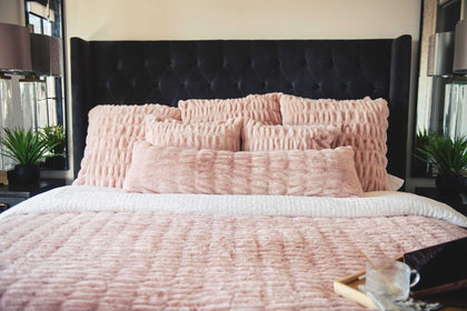 Pink Minky Couture Hugs Blush Sham bedding with matching textured pillows on a bed.