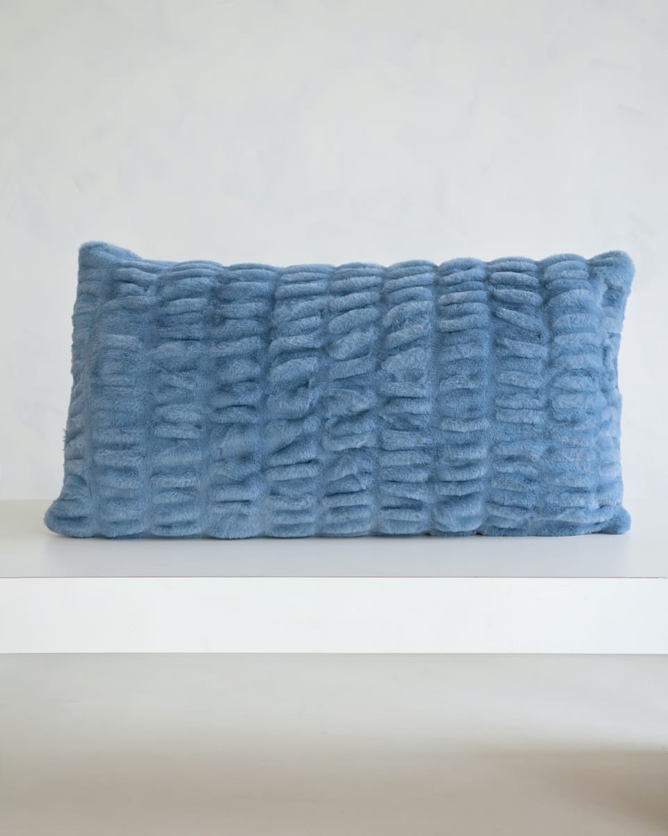 Hugs Denim Sham on a white shelf, featuring a soft, cozy, textured design in timeless denim blue.