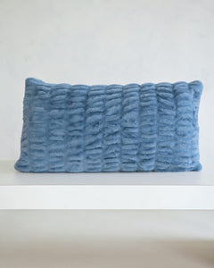 Hugs Denim Sham on a white shelf, featuring a soft, cozy, textured design in timeless denim blue.
