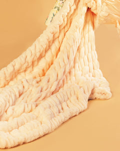 Pastel orange blanket being dragged across a matching colored background.