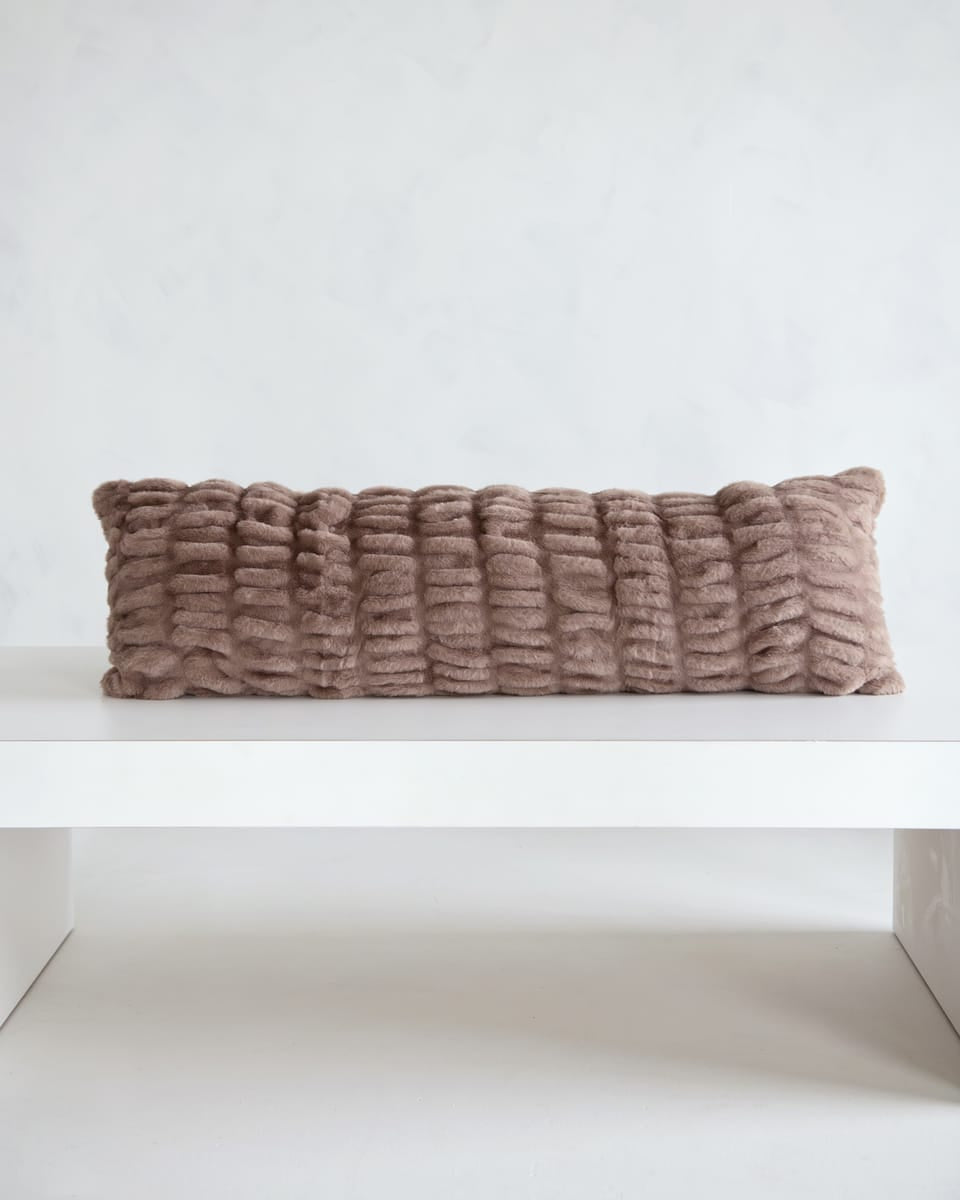 Hugs Milk Chocolate Sham on a white table, showcasing its soft and cozy texture in a light brown hue.