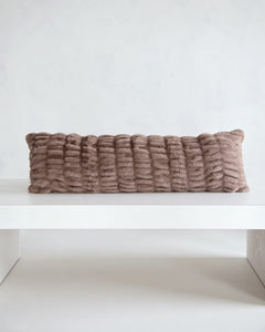 Hugs Milk Chocolate Sham on a white table, showcasing its soft and cozy texture in a light brown hue.