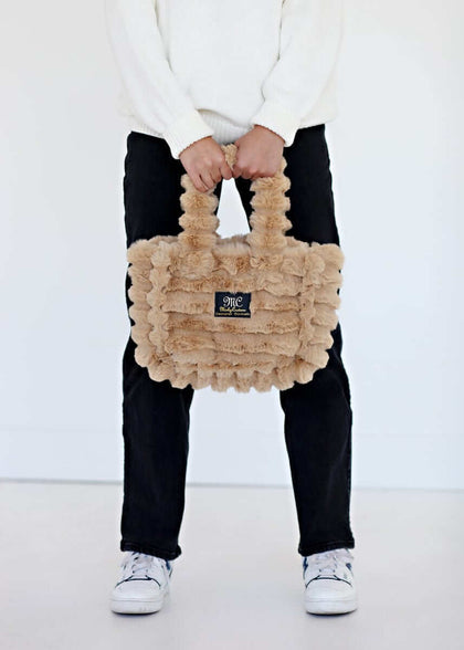 Ripple Ecru Annie Bag held by a model, showcasing luxurious texture and stylish design.