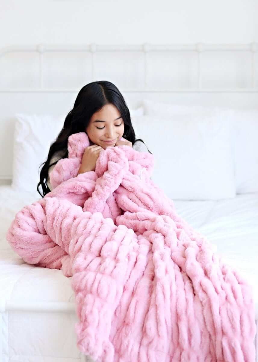 Hugs Cookie Pink Blanket draped over a young woman enjoying comfort and warmth on a cozy bed.