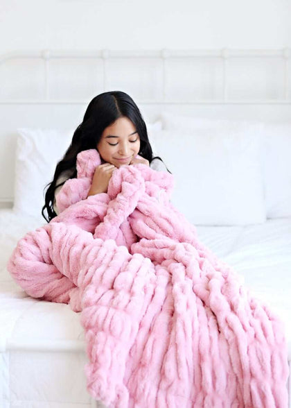 Hugs Cookie Pink Blanket draped over a young woman enjoying comfort and warmth on a cozy bed.