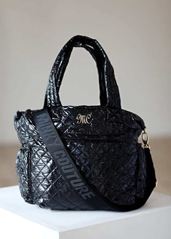Everything Bag Patent Leather Black with quilted design, perfect for travel or daily use.